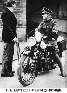 an old black and white photo of two men on a motorbike talking to each other