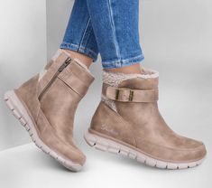 Stay warm and cozy this season in Skechers Synergy - Diva Lane. This zippered high-top sneaker boot features a 3M Scotchgard treated vegan leather upper with faux-shearling shaft detail and buckled wrap strap, a Warm Tech Memory Foam insole, and an anti-slip traction outsole. | Skechers Women's Synergy - Diva Lane Sneaker | Medium Width | Treated with 3M Scotchgard to resist water and stains | Warm Tech Memory Foam cushioned comfort insole is designed to retain body heat | Anti-slip traction outsole under wet and dry conditions | Crafted with 100% vegan materials | Vegan leather upper with faux-shearling shaft detail and buckled wrap strap | High-top sneaker boot with side-zip closure | 1 1/4-inch heel height | Skechers Skechers Women Boots, Skechers Boots, Lane Boots, Winter Boho, Lace Up Wedges, Skechers Women, Shoes Flats Sandals, 4 Inch Heels, Women Boots