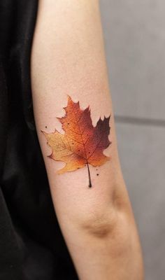 an orange maple leaf on the arm