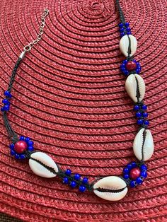 perfect condition handmade with macramed wax linen and cobalt blue seed beads  red miracle luster beads and cowry shells   never worn- never sold from my store inventory that I closed  several years ago Traditional Blue Beach Jewelry, Traditional Blue Jewelry For Beach, Red Macrame Jewelry For Beach, Blue Macrame Necklace For Beach, Traditional Blue Necklaces For Beach, Blue Bohemian Strand Shell Necklace, Bohemian Blue Shell Necklace For Vacation, Unique Blue Beaded Necklace For Beach, Unique Blue Beaded Necklace For The Beach