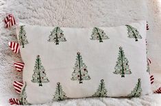 a white pillow with christmas trees on it