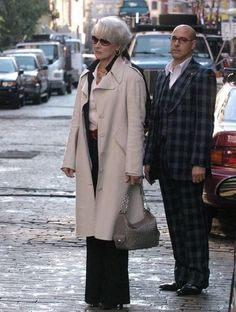 a man and woman are walking down the street