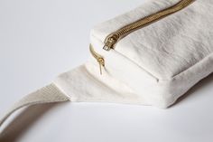 a zippered white bag sitting on top of a table