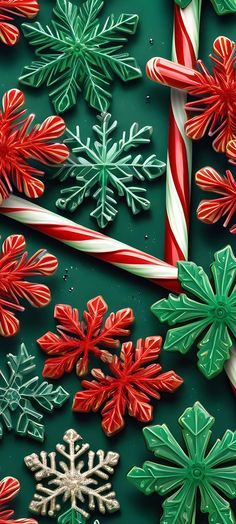 some candy canes and christmas decorations on a green surface