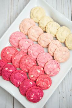 a white plate topped with pink and yellow cookies