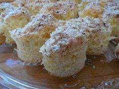 a close up of a muffin on a glass plate with some powdered sugar