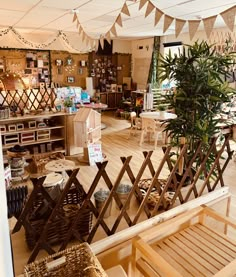 the inside of a store with tables and chairs