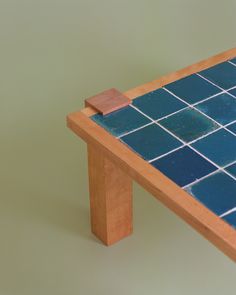 a wooden table with blue tiles on it