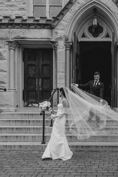 a bride and groom walking down the steps