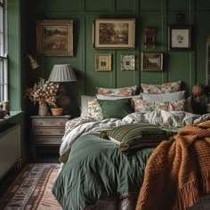 a bedroom with green walls and pictures on the wall