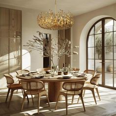 a dining room table with chairs and a chandelier hanging from it's ceiling