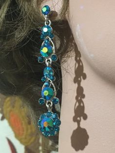 These earrings are made from gorgeous vibrant teal/peacock blue coloured rhinestones. They have an iridescent sheen and are way more stunning in life than the photos show. The colour is breathtaking Dazzling Blue Crystal Earrings, Turquoise Drop Crystal Earrings For Party, Glamorous Blue Drop Earrings, Blue Jeweled Crystal Earrings, Blue Rhinestone Drop Earrings, Blue Sparkling Crystal Earrings, Blue Crystal Earrings With Sparkling Stones, Glamorous Blue Jewelry With Matching Earrings, Blue Rhinestone Dangle Earrings