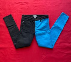 Why choose between two pairs of pants when you can wear both? - Black and Blue - Classic 5-pocket styling with signature Royal Bones grommets - Back pocket design - Size: 5 - In juniors, please check measurements to ensure proper fit. In good condition Please review images for measurements and other details. The item you see is the item you will receive. All items come from a smoke and pet free environment. Edgy Blue Bottoms For Streetwear, Fitted Blue Bottoms For Streetwear, Edgy Mid-rise Blue Bottoms, Edgy Blue Cotton Jeans, Blue Edgy Cotton Jeans, Edgy Blue Mid-rise Bottoms, Edgy Blue Cotton Bottoms, Blue Stretch Jeans With Belt Loops, Trendy Blue Bottoms With Standard Cut Leg