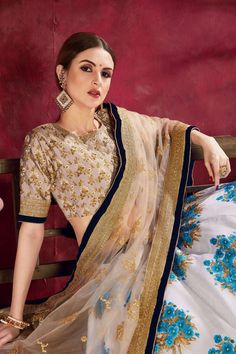 Featuring a Blue Banglori silk  SabyaSachi Designer lehenga choli with floral printing all over enhanced by Zari,Dori and Embroidery work

  As shown it comes with a Banglori silk blouse accompanied by a  Net  dupatta with  embroidered borders in Beige color.
It can be customized up to 42 inches. White Gown With Pallu For Festivals, White Gown With Traditional Drape For Festivals, White Art Silk Lehenga With Intricate Embroidery, White Saree Gown For Navratri, Designer White Lehenga With Sheer Dupatta, Festive White Choli With Sheer Dupatta, White Bollywood Choli With Intricate Embroidery, Designer White Choli With Intricate Embroidery, White Lehenga With Pallu For Reception