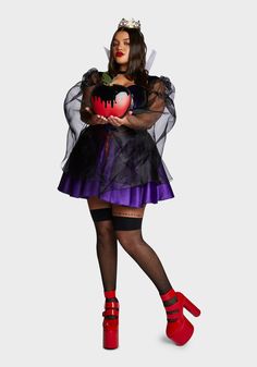 a woman in a costume holding a heart and wearing red shoes with her hands on her hips