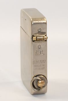 an old style silver lighter on a white background