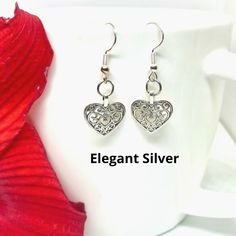 Are you looking for an elegant piece of jewelry that is durable enough to wear everyday? These dangle heart earrings are the perfect accessory! Made from high quality metal alloy (lead and nickel free), these unique and intricately detailed earrings are stylish in their simplicity and make a perfect gift for yourself or a friend! Available in silver or gold color. Dangle length is approximately 1-inch Valentines Earrings, Heart Jewelry, Elegant Earrings, Heart Earrings, 1 Inch, Gold Color, Perfect Gift, High Quality, Silver