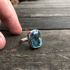 "Glamorous Natural Blue Topaz Ring - Special Piece - Completly Handmade & Silver Gemstone: Natural A Quality Blue Topaz Metal: 925 Sterling Silver Stone Cut: Faced Stone Size: 20.3 mm x 14.6 mm - 0.8 in x 0.57 in Weight: 10 grams (50 carats) total weight of stone and silver. For ring orders, ring resizing is free. Chains are gifts for necklace orders. Note: We don't use any filters for photos. The details may not be clear. Feel free to contact us with any questions, special orders or additional Turquoise Blue Topaz Rings Fine Jewelry, Turquoise Blue Topaz Gemstone Rings, Turquoise Blue Topaz Ring, Turquoise Sapphire Gemstone Ring In Sterling Silver, Turquoise Sapphire Ring In Sterling Silver, Turquoise Sapphire Ring With Sterling Silver, Sterling Silver Turquoise Topaz Ring, Sapphire Topaz Ring With Gemstone Accents In Sterling Silver, Turquoise Blue Topaz Ring With Gemstone Accents