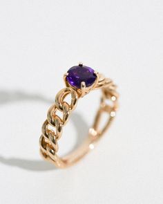 A gleaming centerpiece of your favorite gemstone is set with exquisite artisanal mastery on this unique yet simple ring. Chain links wrap the band of this 14-karat yellow gold ring with a sturdy 6mm round gemstone to top it off. The solitaire design focuses attention to the single mid-sized gemstone while the creative design along the band brings a playful flair for a ring that is truly unique to its wearer. Garnet is a birthstone for the month of January. The orangey red gemstone brings harmony Gold Chain Ring, Ring Chain, Simple Ring, Red Gemstones, Chain Links, Stone Gold, Garnet Rings, Rings Simple, Chain Ring