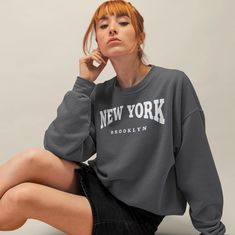 Wrap yourself in the bustling energy of the Big Apple with our New York City Sweatshirt. This wearable masterpiece isn't just a sweater; it's an embrace of the city that never sleeps. With its exceptional coziness and stylish design, it's the perfect addition to your wardrobe or a thoughtful gift for your girlfriend. With seven different colors to choose from, you can find the perfect shade to match your style or mood. Whether you prefer classic neutrals or bold and vibrant hues, our New York Ci City Sweatshirt, Egyptian Inspired, City That Never Sleeps, New York Style, Gifts For Your Girlfriend, Big Apple, Stylish Design, San Jose, Crewneck Sweatshirt