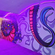 the wall is painted with purple and pink colors, while there are two dragon heads on it