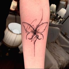 a black and white photo of a butterfly tattoo