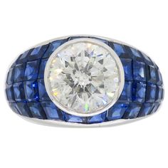 Vintage approximately 2.62CT Round Brilliant Cut diamond ring with blue sapphires set in a mosaic design crafted in platinum Gemstone: Diamond and Sapphire Gemstone Size: Irregular Cut Blue Sapphires ranging from approximately 2.00-2.4mm in size Center Diamond Carat Weight: Approximately 2.62CT Center Diamond Cut: Round Brilliant Cut Center Diamond Color: H-I Center Diamond Clarity: I1 Metal: Platinum Ring Size: 6.5 Marked/Tested: Stamped "PLAT" Weight: 12.2 Grams Luxury Modern Sapphire Ring With Single Cut Diamonds, Sapphire Ring Vintage 1stdibs, Luxury Multi-stone Sapphire Ring In Platinum, Luxury Brilliant Cut Sapphire Gemstones, Luxury Brilliant Cut Platinum Gemstones, Luxury Sapphire Gemstones With Brilliant Cut, Luxury Lab-created Sapphire Ring With Diamond Cut, Luxury Sapphire Diamond Ring With Diamond Cut, Luxury Sapphire-colored Diamond Ring With Diamond Cut