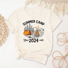 Summer Camp 2024 Shirt, Camping Life Shirts, Campfire T-Shirts, Adventure Lovers Shirt, Summer Camper Tee,  Family Camp Tees, Camping Gift We wish everyone to smile with our cute, stylish, and trendy graphic T-shirts. We assure you this shirt is the perfect gift whether you buy it for yourself or someone else. Black text is only used for White, Athletic Heather, Baby Blue, Natural, Orange, Yellow, Heather Peach, Pink, Mint, Cancun, Banana Cream, and Desert Pink colored shirts. White text is used Desert Pink, Camping Tee, Banana Cream, Camping Gifts, Camping Life, Family Camping, Crew Neck Shirt, Peach Pink, Cancun