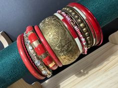 An armful of vintage stacking bangles  mixed medium bangle stack made up of metal enamel wood and brass retro slim and wide coloured boho festival bracelets. You will receive all as shown in the photos  Approx 9cm stack ... exact width is shown in the photos  Approx 65mm internal diameter. Standard bangle size Affordable Handmade Red Bangle, Vintage Red Bracelets For Festival, Red Vintage Bracelets For Festivals, Red Bohemian Bangle For Festive Occasions, Red Bohemian Stackable Bracelets, Red Cuff Bangle For Festival, Red Cuff Bangle Bracelet For Festival, Red Bangle Cuff Bracelet For Festival, Vintage Multicolor Festival Bangle