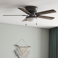 a ceiling fan mounted to the side of a wall