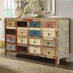 an old dresser with many drawers and knobs on it's doors is shown in front of a mirror