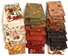 many different types of cloths are stacked on top of each other