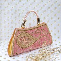 Rumana Luxury Zardosi Embroidered with Hand crafted hand Purse with handle.  Perfect for evening parties and a special ocassion.  We try to take pictures as normal as we can but colors may slightly vary due to different lighting setups. Please note: No Returns No Exchange. But If you have any issue with your order, Kindly contact us before leaving a review Traditional Pink Shoulder Bag For Evening, Pink Bags For Evening And Festivals, Pink Embellished Clutch Bag, Pink Shoulder Bag With Handwork For Party, Elegant Pink Shoulder Bag For Festivals, Pink Embellished Handheld Shoulder Bag, Traditional Handheld Embellished Evening Bag, Traditional Embellished Handheld Evening Bag, Pink Rectangular Shoulder Bag With Handwork