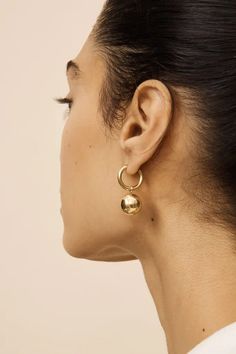 1.Exquisite Design: These dangle huggie earrings boast a contemporary yet classic design, featuring a delicate balance of simplicity and elegance. The 18k gold plating adds a touch of luxury, making them suitable for both everyday wear and special occasions. The dangle hoop design, with a ball drop accent, adds a playful charm to these gold earrings. 2.The gold huggie hoop earrings approx inner diameter are 14mm, outter diameter 18mm, thickness 2mm. The gold beads, with dimensions of 14mm*14mm, lend a noticeable yet refined touch to the overall aesthetic. The 18k gold plating not only enhances the aesthetics of the big earrings, but also ensures durability. The classic gold hoop earrings are full of luster, not easy to rust and discolor, which are durable and comfortable to wear. 3.Two Way Modern Single Sphere Earring, Modern Clip-on Earrings For Everyday Wear, Modern Everyday Clip-on Earrings, Modern Clip-on Huggie Earrings, Elegant Brass Dangle Huggie Earrings, Minimalist Single Brass Huggie Earring, Minimalist Brass Single Huggie Earring, Minimalist Dangle Hoop Earrings, Modern Gold Plated Dangle Hoop Earrings