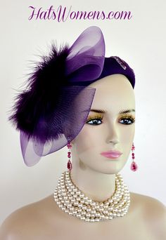 Ladies Purple Custom Made Winter Wool Pillbox Designer Fashion Cocktail Party Hat. This Elegant Ladies Hat Is Inspired By The 1920s Flapper And Art Deco Era Hats. This Dress Hat Is Trimmed With Pearl And Light Purple Lavender Sequin Glass Beaded Pearl Flower Appliques. A Dramatic Purple Horsehair Crinoline Bow Is Placed On This Formal Hat Accented With Purple Fur Like Feathers.

This dress hat is suited for Winter, And Fall.

Material: Purple Wool
Head Size: 22.5 Inches - Shallow Crown Hat, A Hat Pin Is Included To Secure This Hat On Your Head
Crown Width: 7 Inches

This Women's Hat Is Suited For Cocktail Parties, Weddings, Holidays, Formals, The Kentucky Derby, And Special Occasions. Weddings And Formals. Women's Designer Hats Specializes In Custom Made Designer Hats For Women, Cocktail H Church Wedding Dress, Special Occasion Hats, Weddings Dress, Avant Garde Dresses, Formal Hat, Church Weddings, Head Crown, Occasion Hats, Bridal Fascinator