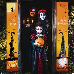 two people dressed up in halloween costumes holding pumpkins and standing outside an open door