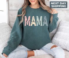 "Comfort Colors® Blessed Mama Sweatshirt,  Cute Mom Sweatshirt, Mother Tee, Cute Mom Sweat, Cute Mom Gift, Mothers Day Gift, New Mom Gift Hi! WELCOME TO DELUXSTOREUSA This sweatshirt perfect gift as a holiday apparel. Ideal for any situation, a unisex heavy blend crewneck sweatshirt is pure comfort  Washing Care Instructors Use cold water when washing, do not use bleach, do not dry clean, and do not use an iron directly on the design.  Production Time Production time is 1-2 days. Delivery time varies depending on your delivery address. How to Order?   Please, choose your favorite color and size from the pop-up window.  Select the quantity that you want.  Click \"ADD TO CART\".  You can go back to add more product color for your loved ones members.  You can complete the checkout process.  P Crew Neck Top For Mother's Day Loungewear, Crew Neck Top For Loungewear On Mother's Day, Crew Neck Top For Loungewear, Casual Tops For Mother's Day Loungewear, Soft-washed Crew Neck Tops For Mother's Day, Long Sleeve Tops With Letter Print For Mother's Day, Long Sleeve Tops For Mother's Day Loungewear, Green Long Sleeve Tops For Mother's Day, Holiday Apparel