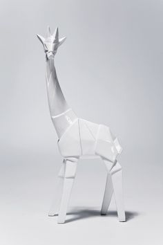 an origami giraffe is standing in the middle of a gray background