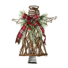 a christmas tree made out of branches with red and green plaid bow on top, standing upright