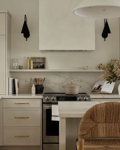 a kitchen with an oven, stove and chairs