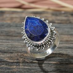 Item Name :- Solid 925 Sterling Silver Natural Lapis lazuli Ring Metal:-  Solid 925 Sterling Silver Quantity :- 1 Piece Ring Size :- All Size Available Gemstone :- Lapis lazuli  Shape  :- Pear Stone Size :- 40X20 MM  Weight :- 12.78 Gram Approx Gemstone Color :-  Blue Color Band Color :- Silver  About Gemstone -  Lapis Lazuli assists to confront and speak one's truth and inspires confidence. It bonds relationships, aiding in expression of feelings and emotions. Lapis Lazuli boosts the immune sys Blue Sterling Silver Crystal Ring With Natural Stones, Blue Natural Stone Crystal Ring In Sterling Silver, Bohemian Blue Crystal Ring In Sterling Silver, Bohemian Blue Crystal Sterling Silver Ring, Bohemian Blue Birthstone Ring, Spiritual Blue Crystal Ring In Sterling Silver, Spiritual Blue Sterling Silver Crystal Ring, Bohemian Sapphire Rings For Gifts, Bohemian Sapphire Ring As A Gift