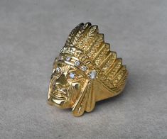 Truly stunning large American Indian Chief ring. Made from almost an ounce of solid 14K yellow gold, with gorgeous VS1 clarity, F color genuine diamonds. This beauty is hand crafted with great design details, and a high polished finish. Ring comes with our company stamp/logo, which includes our signature Sapphire. Most ring sizes are available, please choose your ring size from the ring size menu on top. Ring specs: * Indian Chief head is 32mm (1.25 inch) tall, by 24mm wide (1 inch). * Diamonds Luxury Gold Diamond Ring Collectible, Collectible Gold Rings With Diamond Accents, Paul Jackson, Stamp Logo, Vs1 Diamond, Pandora Necklace, Horse Necklace, Indian Chief, Indian Head