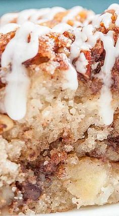 a close up of a piece of cake on a plate with icing drizzled