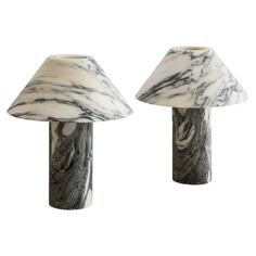 two marbled lamps are sitting next to each other