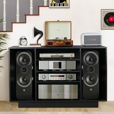 a black entertainment center with speakers and an old record player