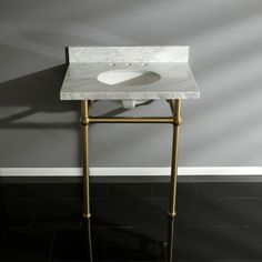 a white sink sitting on top of a marble counter