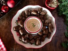 a white plate topped with meatballs and dipping sauce