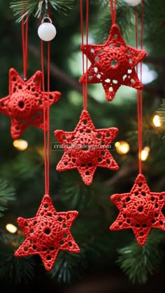 red crocheted ornaments hanging from a christmas tree