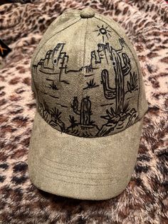 This custom burned desert/cactus will be a great addition to any western look this fall/winter. This suede feel cap is fully adjustable with a clasp backing. Perfect for men or women.  I can add names, dates or other details at no additional cost. Cactus Burned Hat, Adjustable Casual Baseball Cap For Rodeo, Western Style Outdoor Baseball Cap, Western Style Adjustable Baseball Cap With Curved Brim, Western Style Adjustable Baseball Cap With Flat Brim, Western Style Adjustable Flat Brim Baseball Cap, Adjustable Western Baseball Cap For Outdoor, Western Style Adjustable Baseball Cap For Outdoor, Casual Hats For Western-themed Events