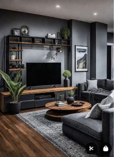 a living room filled with furniture and a flat screen tv on top of a wooden table